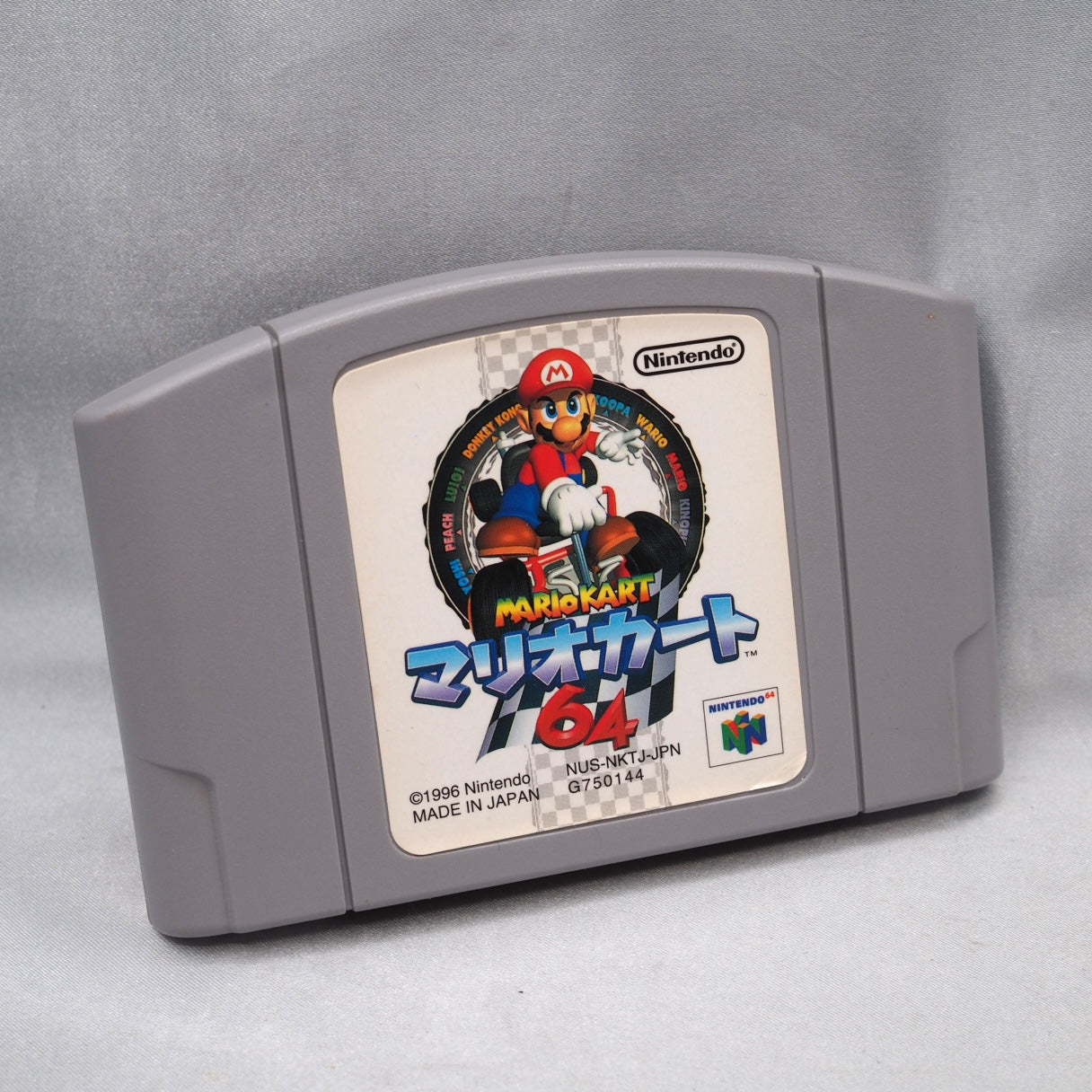 Blue shell targets only human racers, never CPU. Mario Kart 64 (N64, 1996) sold 9.87 million and defined Saturday-night couch